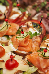 different snacks with red salted fish close-up