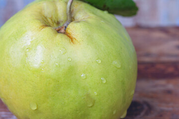 closeup ripe fresh quince on wooden board
