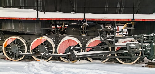 Locomotive wheels close-up with snow in winter © Александр Коликов