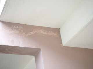 Rain water leaks on the wall house causing damage and peeling paint. closeup photo, blurred.