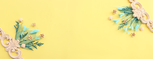 Top view image of autumn forest natural composition over yellow background .Flat lay