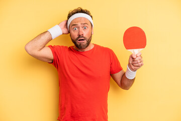 middle age man feeling stressed, anxious or scared, with hands on head. ping pong concept