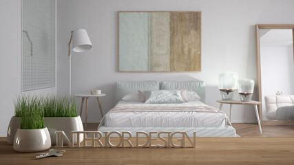 Wooden table, desk or shelf with potted grass plant, house keys and 3D letters making the words interior design, over modern minimalist bedroom, project concept copy space background