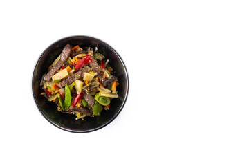 Beef, vegetables and sesame seeds in black bowl isolated on white background. Top view. Copy space