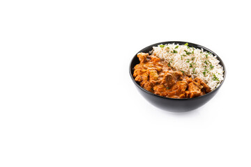 Indian butter chicken in black bowl isolated on white background. Copy space