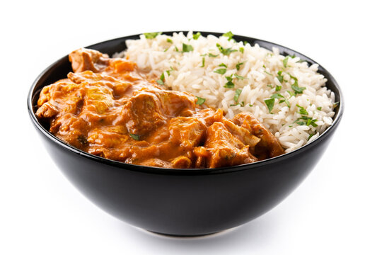 Indian butter chicken in black bowl isolated on white background