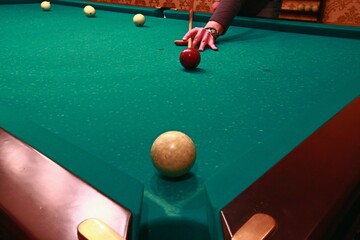 Billiard balls on a green table cloth.