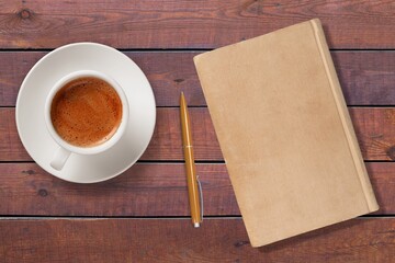 blank antique journal with paper pages with a stylish pen and cup of tea