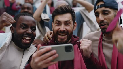 Multiracial friends using mobile for watching soccer game