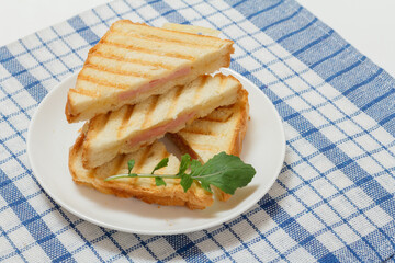 Homemade grilled cheese sandwich for breakfast on plate.