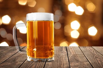 Beer in mug on wooden table with Christmas background