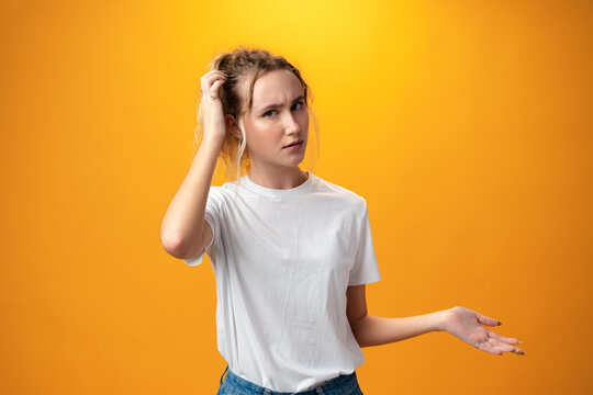 Young Beautiful Woman Thinking Looking To The Side Against Yellow Background