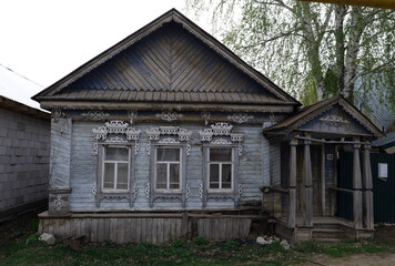 wooden country house with carved patterns on the windows