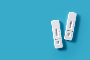 Covid-19 rapid antigen test on blue background. Copy space