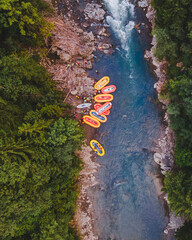 aerial view of mountain river people rafting in creek