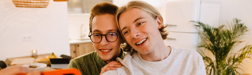 European gay couple hugging and smiling while spending time together