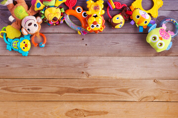 Set of toys for newborn on wooden background. top view