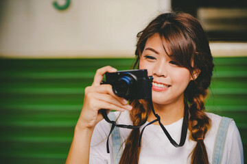 Asian young girl taking photo, happy traveler by the train