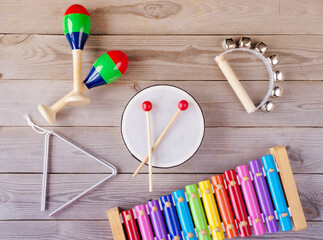 music accessories for children on wooden background. top view.