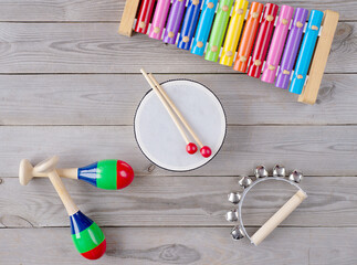 music accessories for children on wooden background. top view.