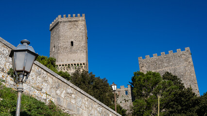 Fototapeta na wymiar Erice, Sicily, Italy. Glimpse of the castle of Venus with street lamps and blue sky