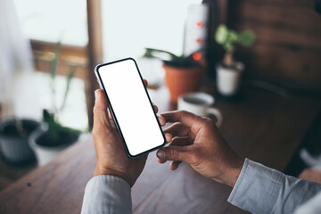 cell phone blank white screen mockup.hand holding texting using mobile on desk at office.background empty space for advertise.work people contact marketing business,technology