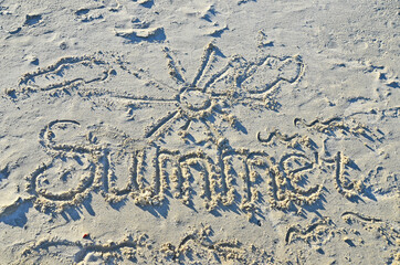 Word summer, written in sand
