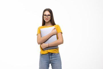 Successful woman holding a laptop isolated over white background