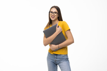 Successful woman holding a laptop isolated over white background