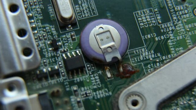 The laptop's motherboard is rotating. Computer processor, microchips, semiconductors, capacitors, bios battery.