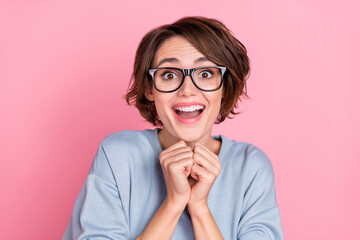 Portrait of attractive cheerful girly impressed girl having fun great news isolated over pink pastel color background
