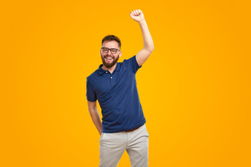 Victorious man celebrating success with fist up