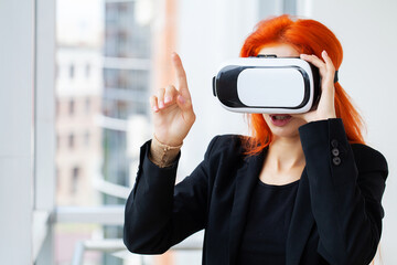 Pretty woman using vr headset sitting and resting at workplace