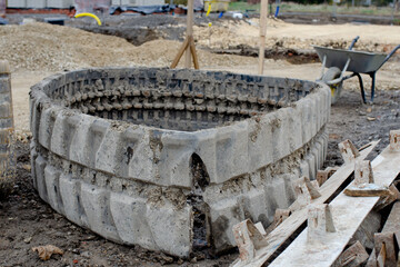 Broken rubber track fell of excavator and laying on construction site awaiting to be replaced