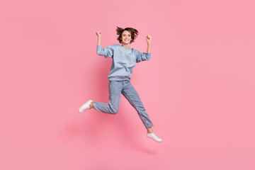 Fototapeta na wymiar Full length photo of celebrate young lady jump yell wear jumper jeans footwear isolated on pink background
