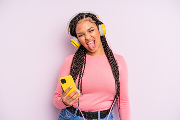 black afro woman with cheerful and rebellious attitude, joking and sticking tongue out. listening...