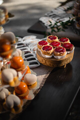 Dessert table for a party. Ombre cake, cupcakes, sweetness and other sweets. Vertical view for social media