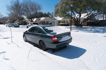 Suburban houses, sidewalk and vehicle covered in snow storm after historic blizzard near Dallas, Texas, USA