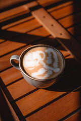 Coffee cup with cream or milk, top view on beautiful wooden background. Great picture for baner or menu