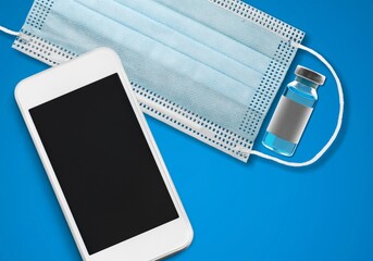 On a medical mask with a smartphone. Global financial crisis