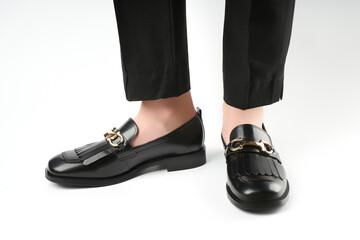 Loafers isolated on white background. Pair of Stylish Expensive Modern Leather Black Loafers Shoes. Fashion concept with woman shoes on white.