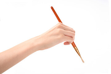 Female hand with brush on white background. Hand with a brush
