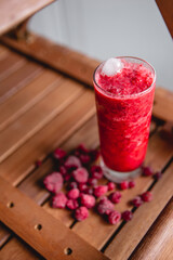 Summer red drink coctail in glass jar, with fresh berries on wooden table