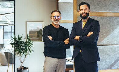 Two successful businessmen smiling at the camera