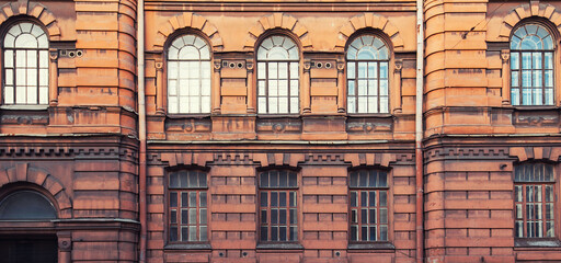 Vintage building facade with windows and balconies. Old building facade wall. Traditional architecture, St Petersburg, Russia. Historic architecture.