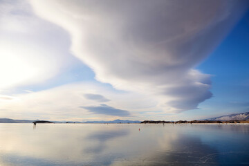 Lenticular cloud over the frozen Lake Baikal. Winter landscape. Aerial view . 