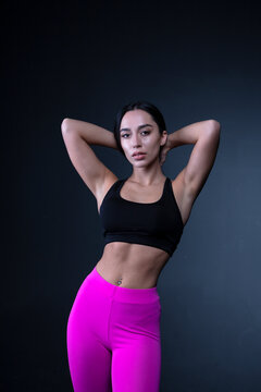 Athletic natural woman body on dark background. 

