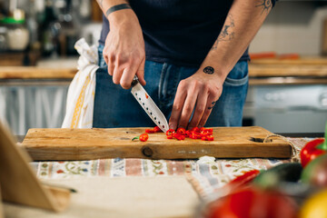 close up of man cutting red paprika