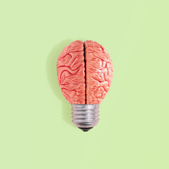 Minimal abstract surreal conceptual composition made of bulb and model of human brain isolated on...