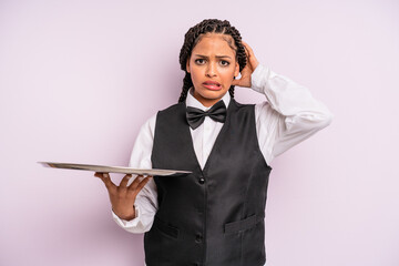 afro black woman feeling stressed, anxious or scared, with hands on head. waiter with a tray